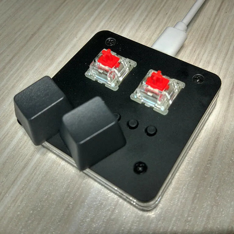 Compact white mini USB keyboard with a touch panel and multimedia keys on a desk.