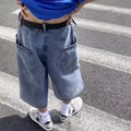 Men's washed light blue denim cropped shorts with a high waist and zipper fly.