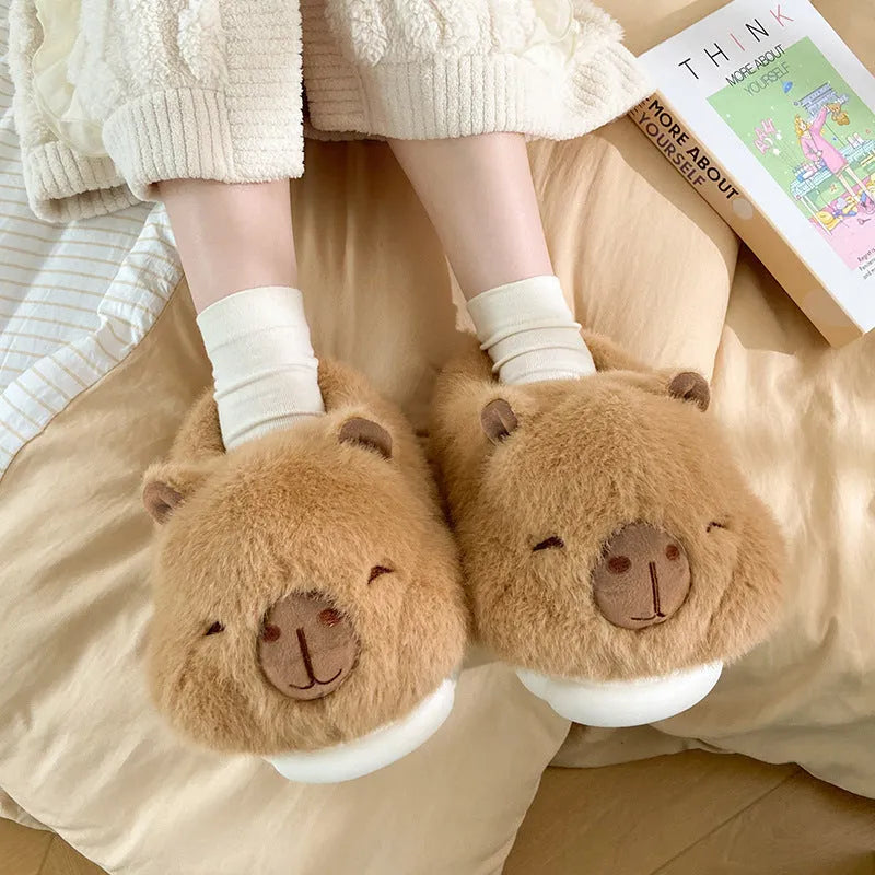 Light brown women's winter slippers with cotton plush upper and cartoon pattern.