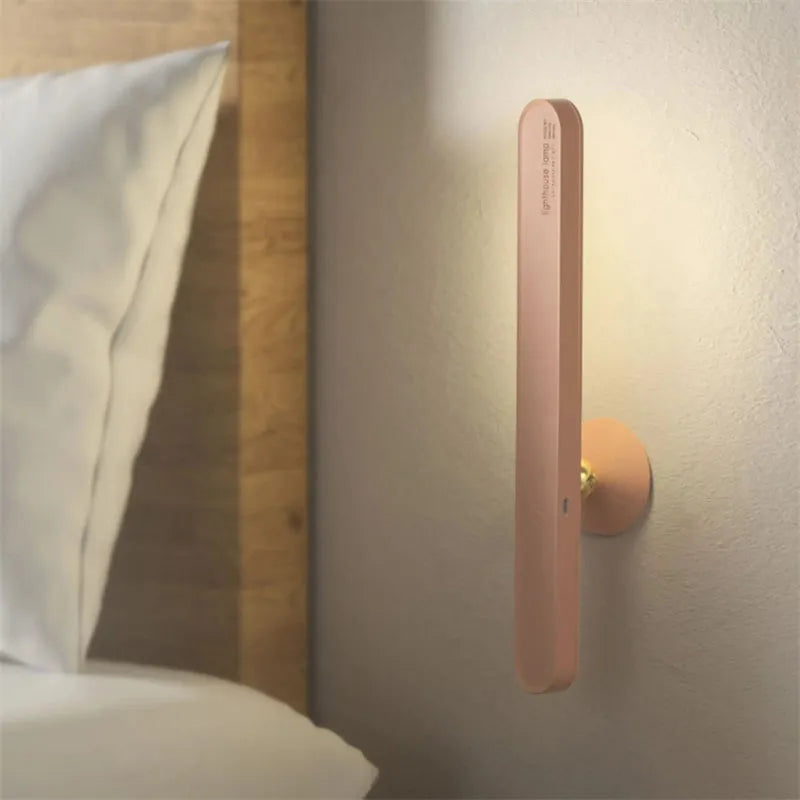 Geometric design table lamp with magnetic base on desk next to USB cable