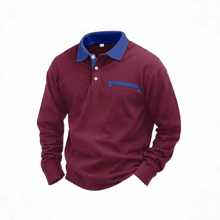 Man wearing a long-sleeved waffle-texture polo shirt with an asymmetric design in a dark colour.