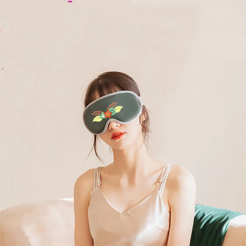 Green portable eye SPA mask showing suede shell and contoured shape for steam heat and vibration massage.