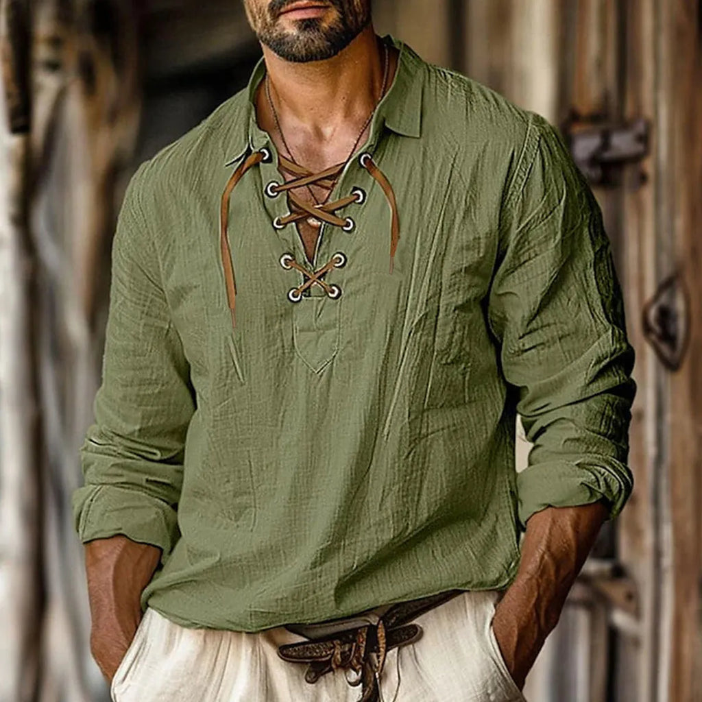 Man wearing a solid blue loose-fit linen blend shirt with lapels and lace detailing on the front.