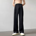 Black loose-fit wide-leg trousers with straight cut on a hanger.