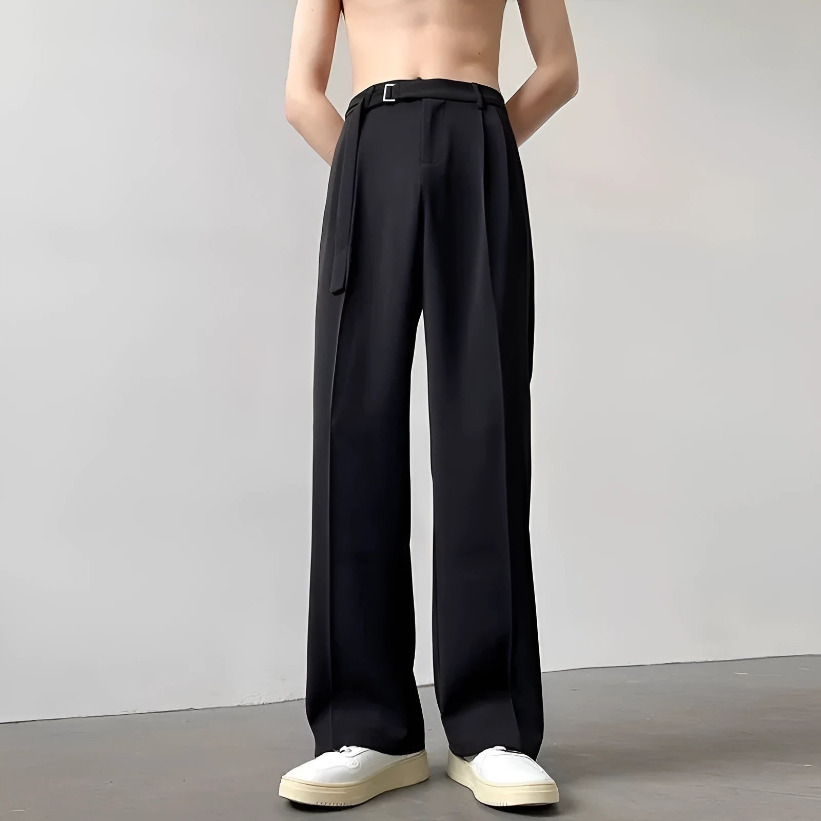 Black loose-fit wide-leg trousers with straight cut on a hanger.