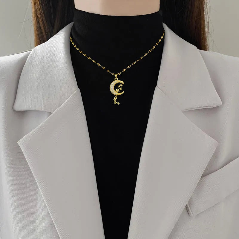 Geometric moon pendant necklace with tassel detailing and diamond accents on copper