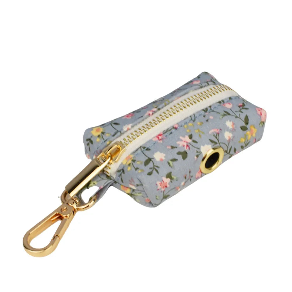 Blue floral patterned fabric bow attached to a decorative dog collar for pets