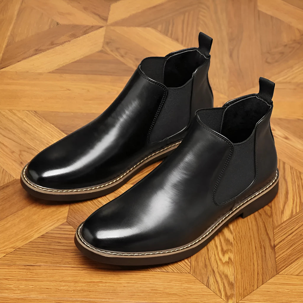 Black and brown formal pointed-toe leather boots with a square heel and rubber sole.