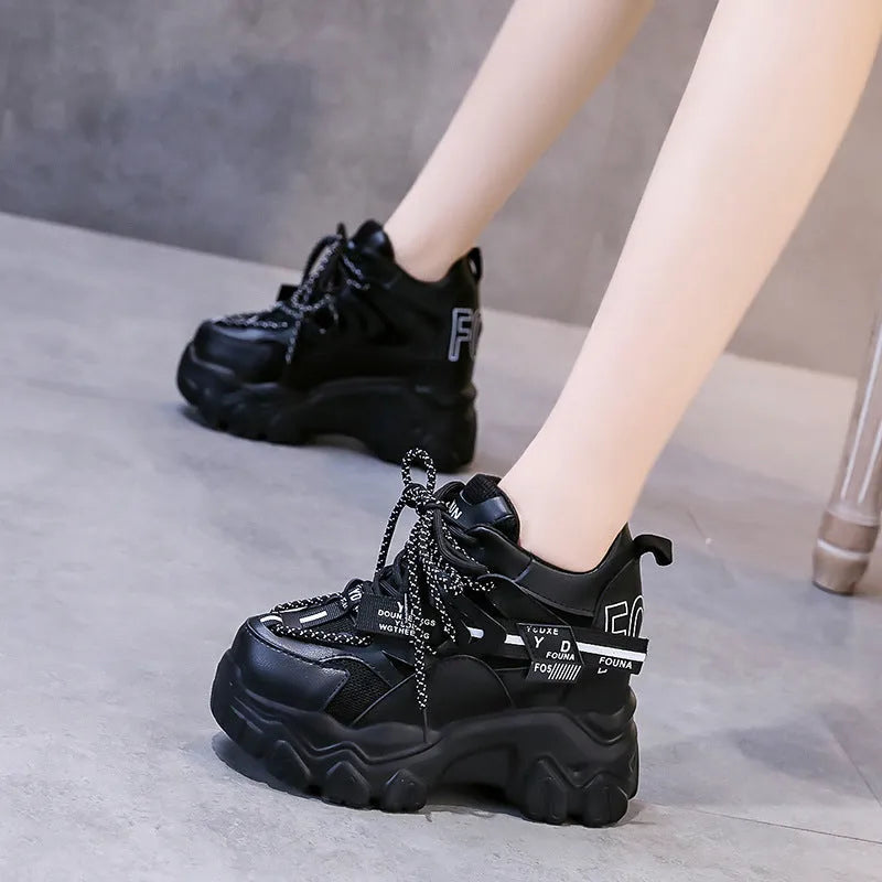 Women's white low-top platform tennis shoes with mesh upper and cross-strap detail on a rubber sole.