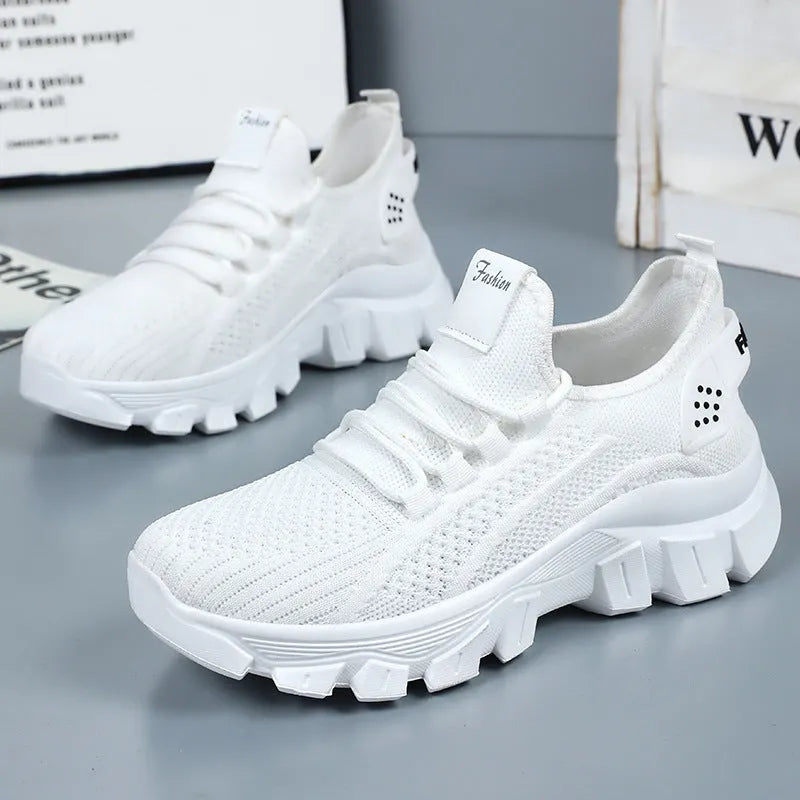 Women's white flyknit sneakers with round toe and flat PVC sole