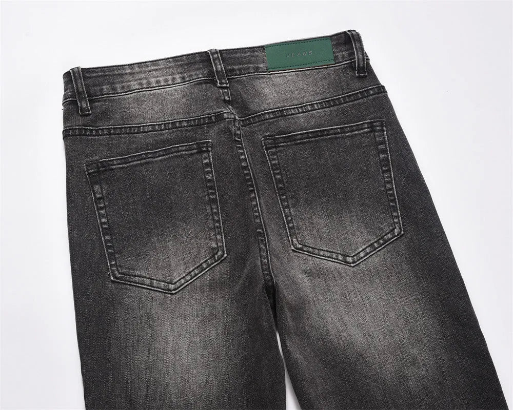 Men's black washed wear-white denim jeans on a plain background showing front view