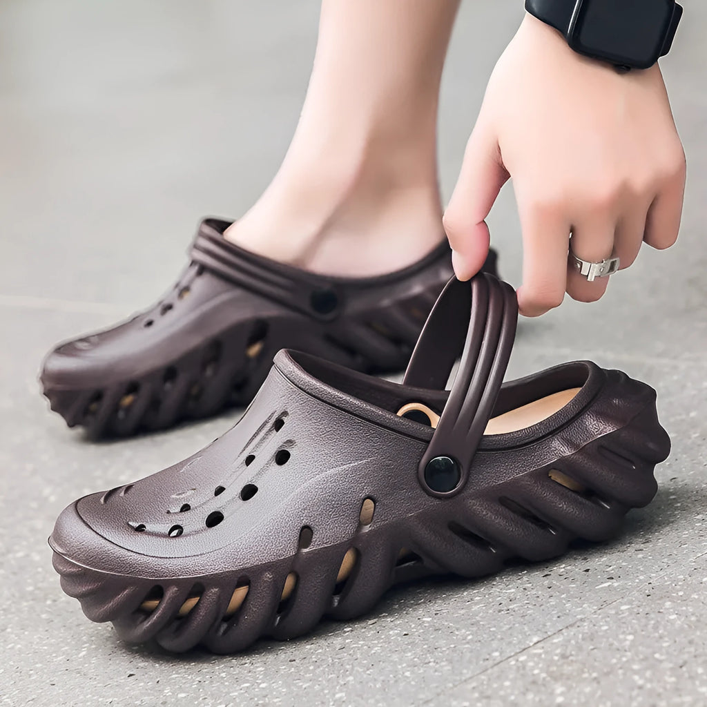 Men's beige hollow out slippers with non-slip soles showing EVA construction and round toe design