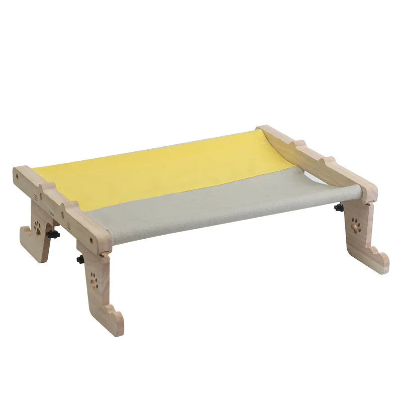 Wooden frame cat hanging bed with fabric hammock mounted by a window