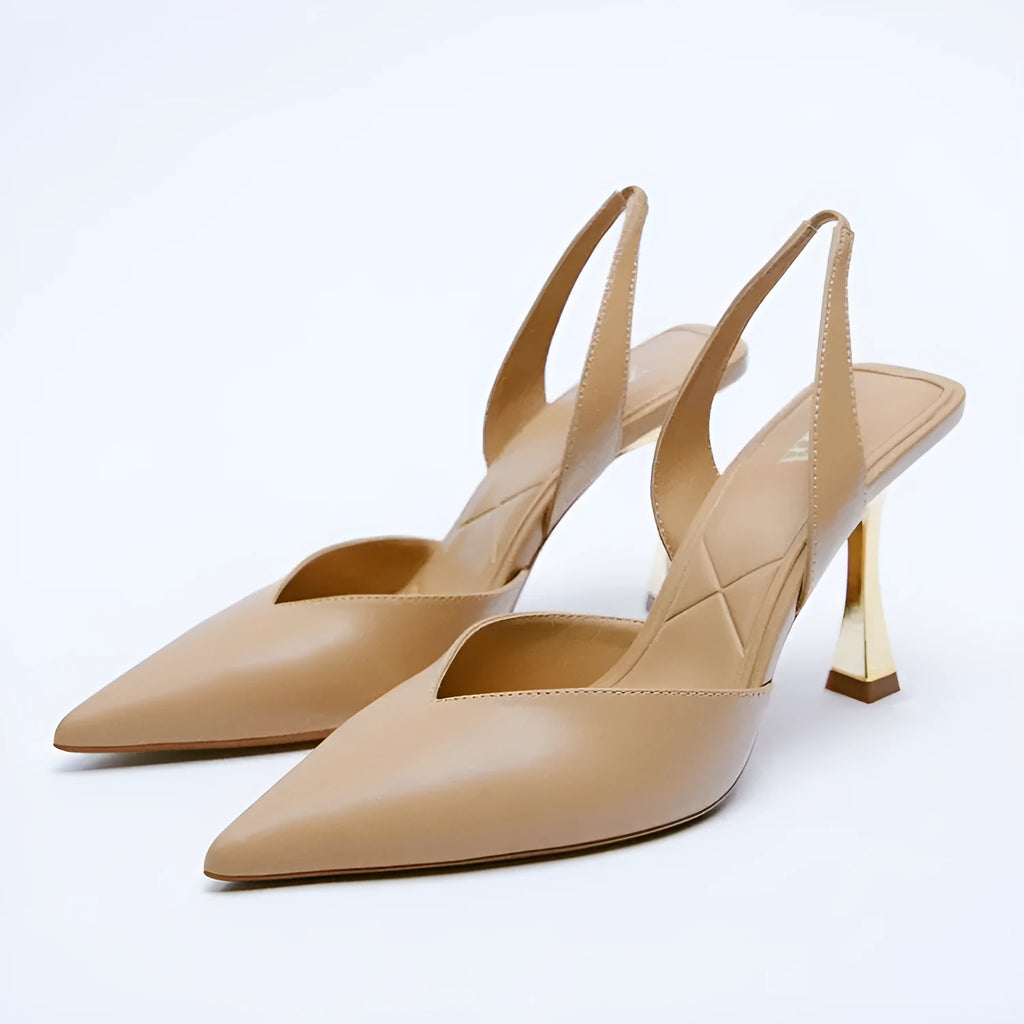 Women's pointed patent leather high heels in nude apricot colour with a shallow mouth design.