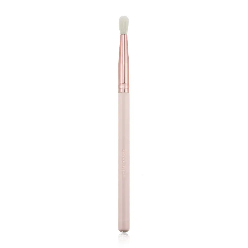 26 pink makeup brushes with wooden handles laid out next to a matching storage bag.