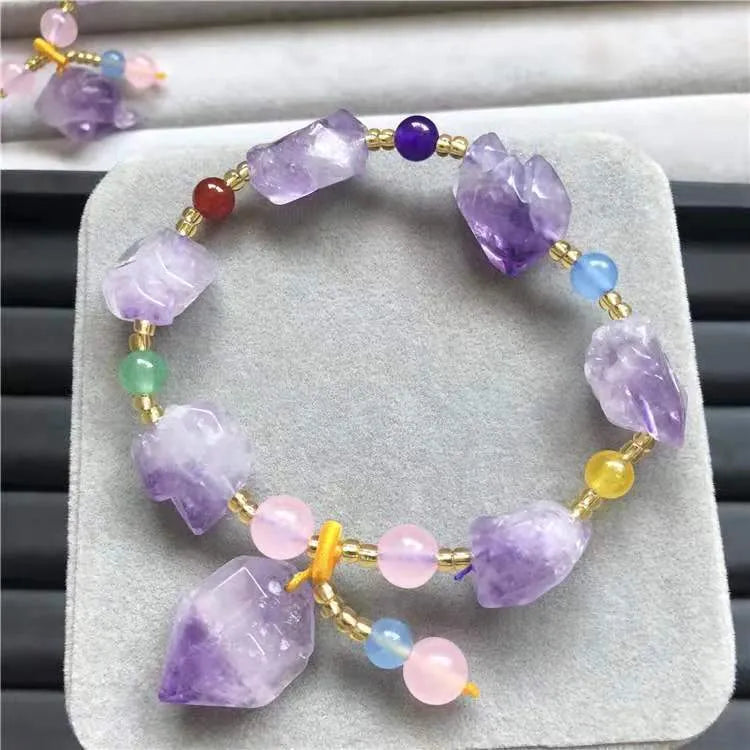 Natural amethyst bracelet with fu charm on woman's wrist