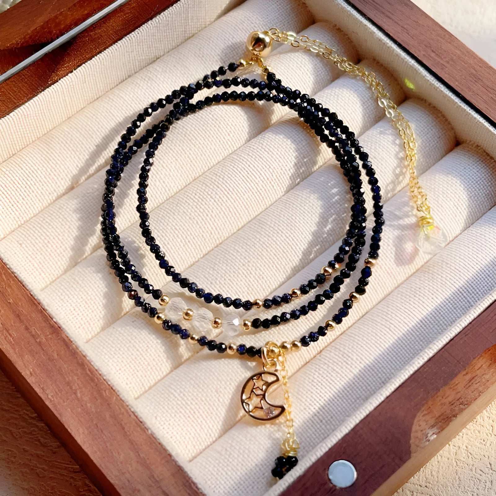 Close-up of a blue sandstone and gold multi-layer three-ring bracelet for women.