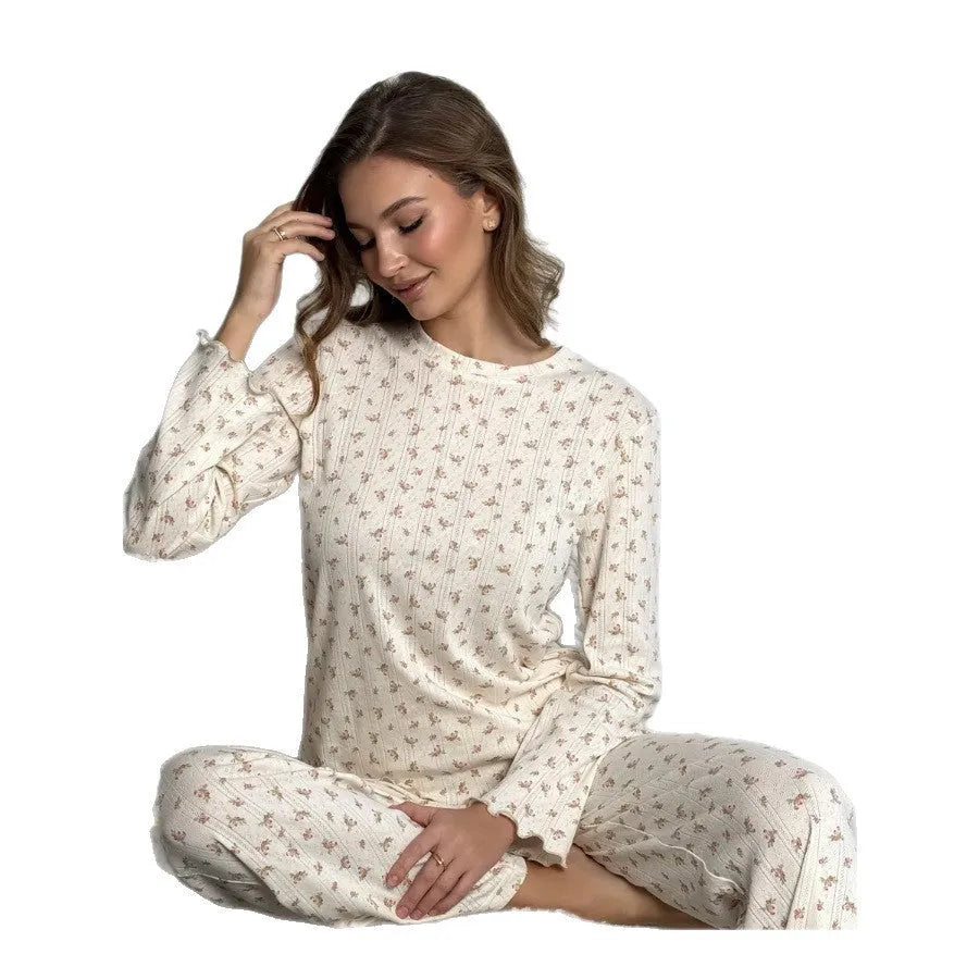 White women's floral print polyester two-piece suit with bell sleeve top and wide-leg trousers.