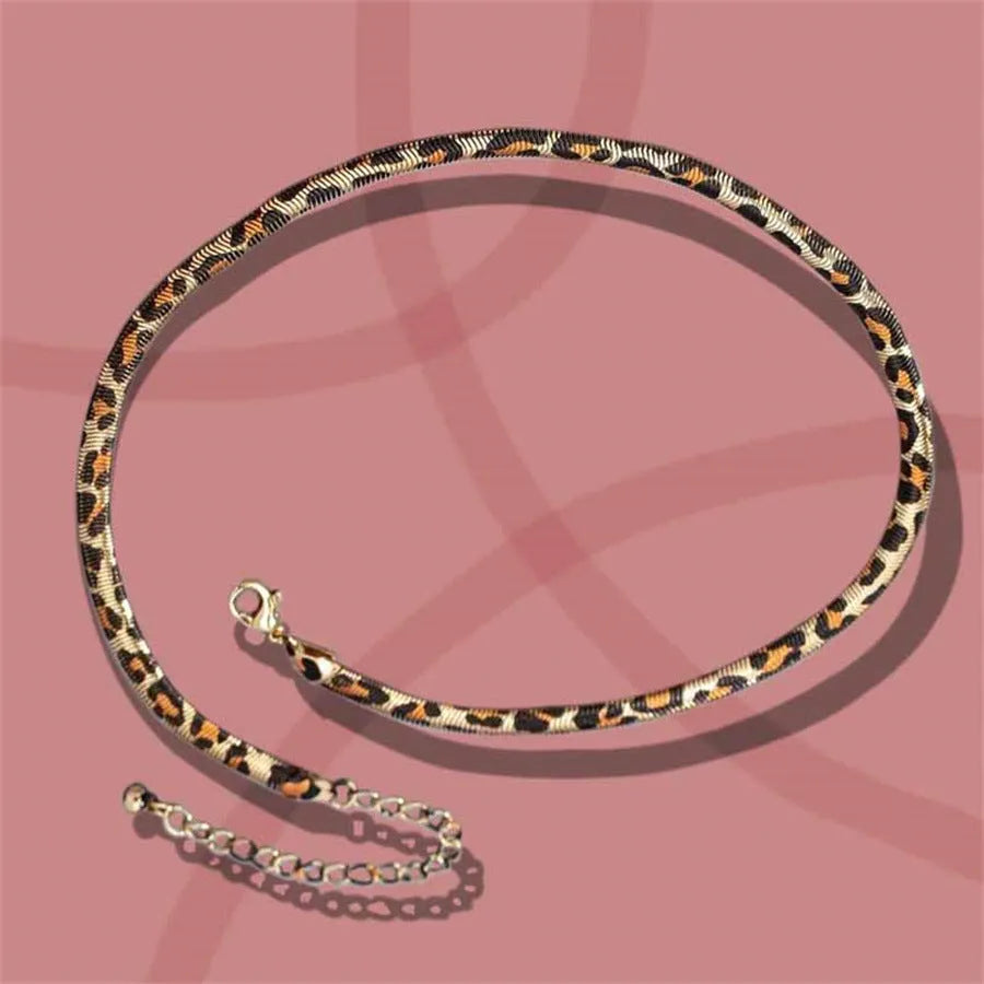 Women's alloy leopard necklace with leopard print motif against a neutral background
