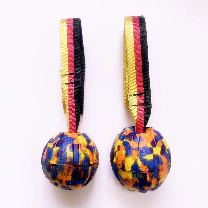EVA floating dog training ball in camouflage colour and yellow, shown in 65mm, 7cm, and 9cm diameter sizes.