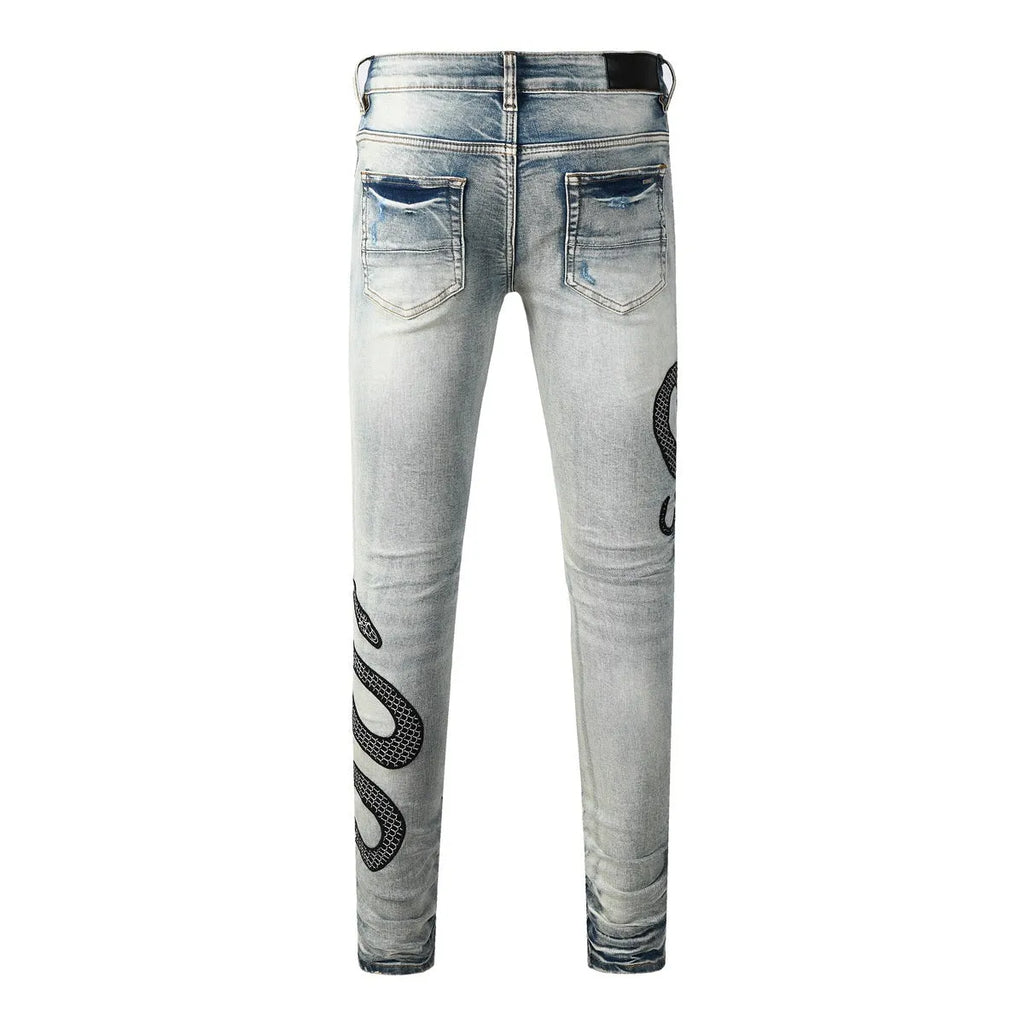Blue distressed street fashion skinny jeans with a button fly and mid-rise waist on a hanger.