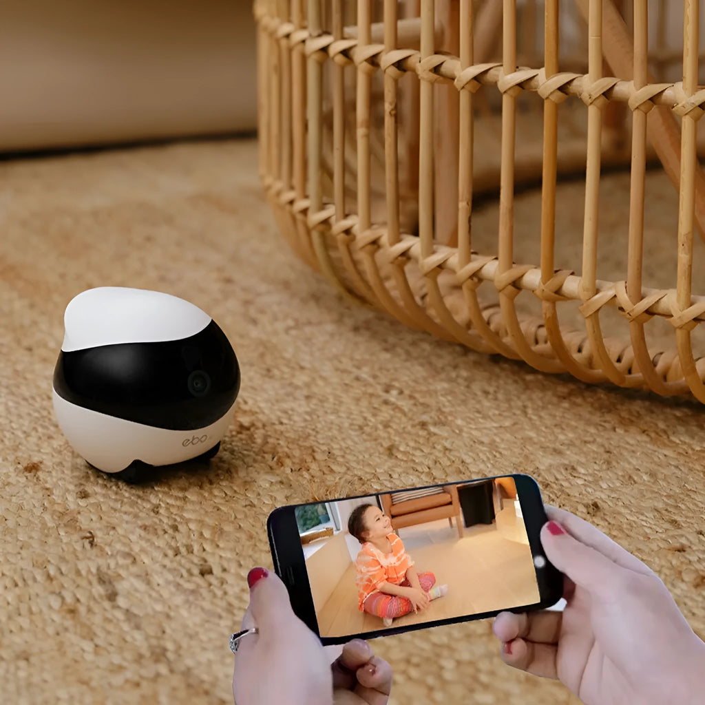 Compact white smart home surveillance robot camera with automatic docking station