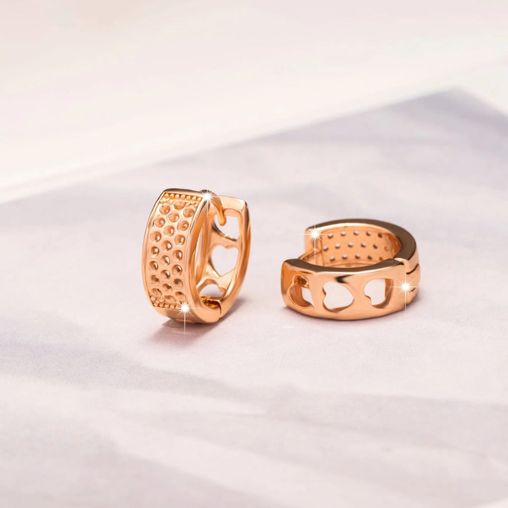 Rose gold circular women's earrings with a hollowed-out three-heart design.