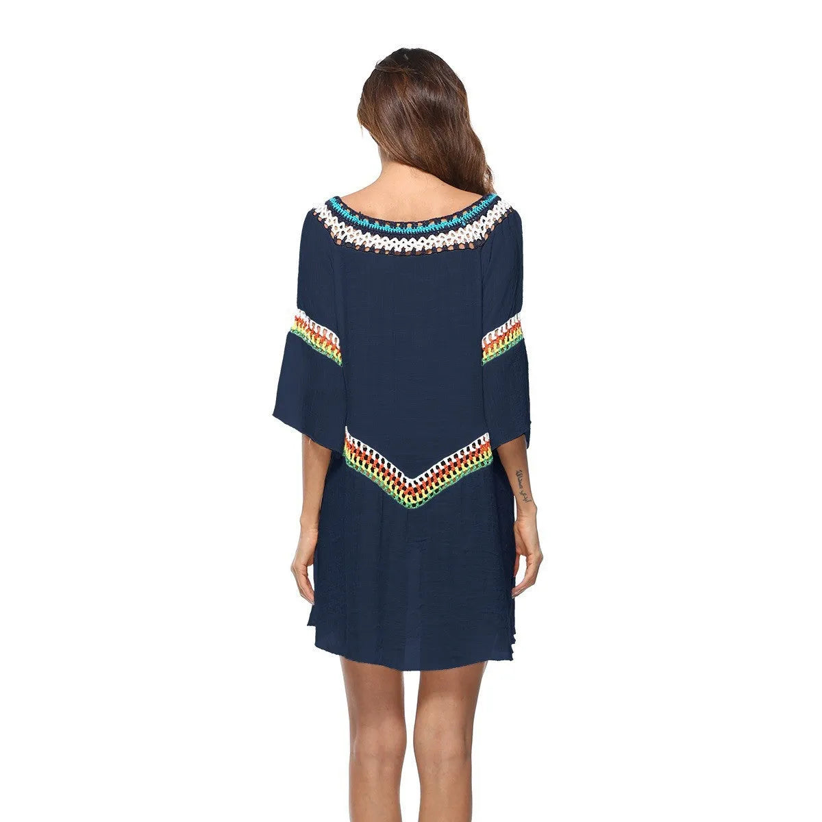 Crocheted ethnic-style white acrylic beach cover-up for women on a mannequin