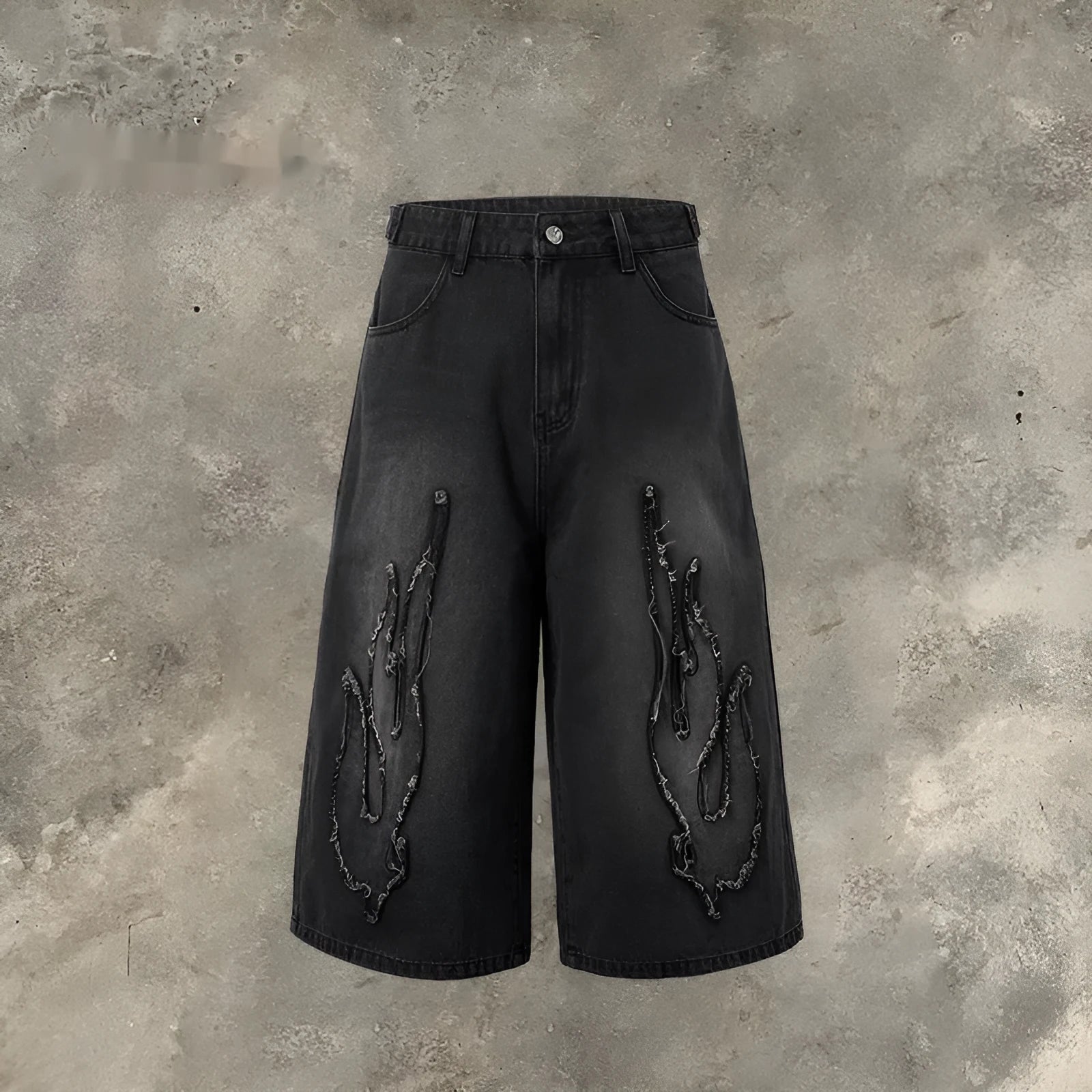 Men's black denim shorts with a cropped flame embroidery patch on the leg