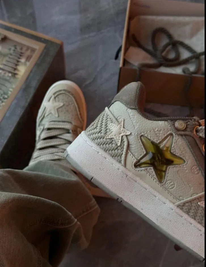 Green low-top canvas casual shoes with star pattern and white stitching on a rubber sole.