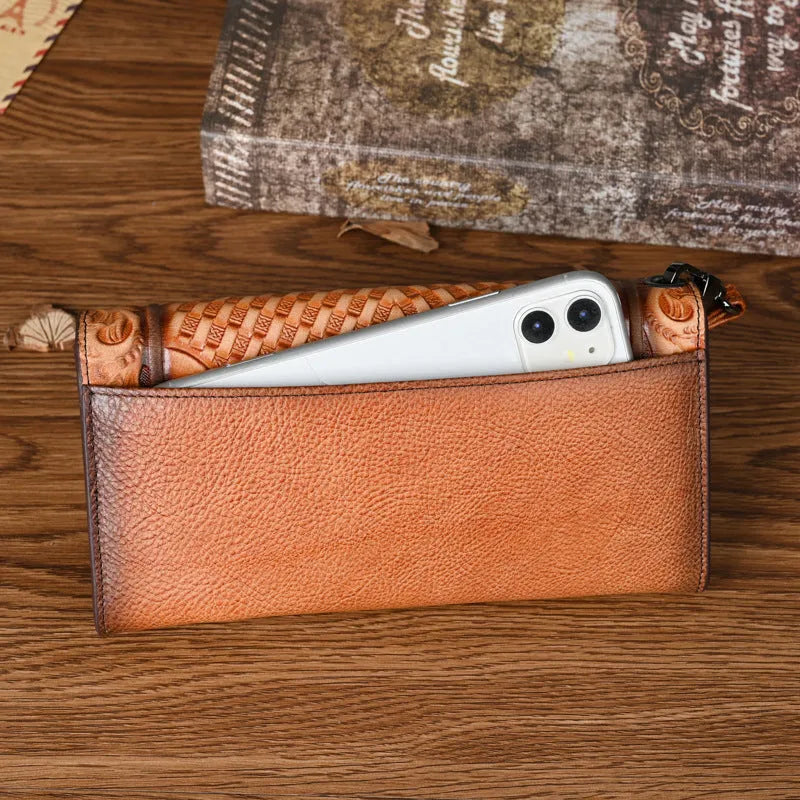 Women's brown genuine leather tri-fold wallet with embossed floral pattern showing interior compartments