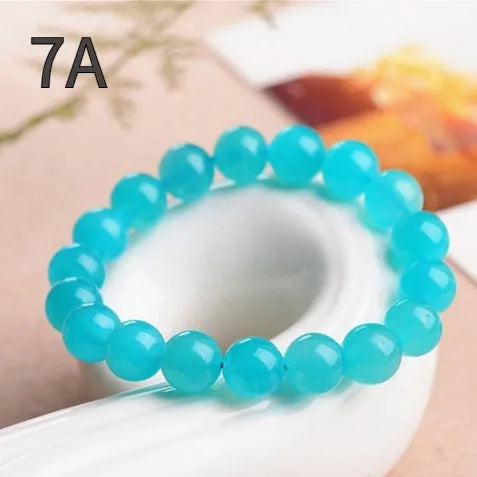 Grade 7A Amazonite natural scattered beads in ice blue and green, showing polished round and three-ring bead styles for bracelet making.