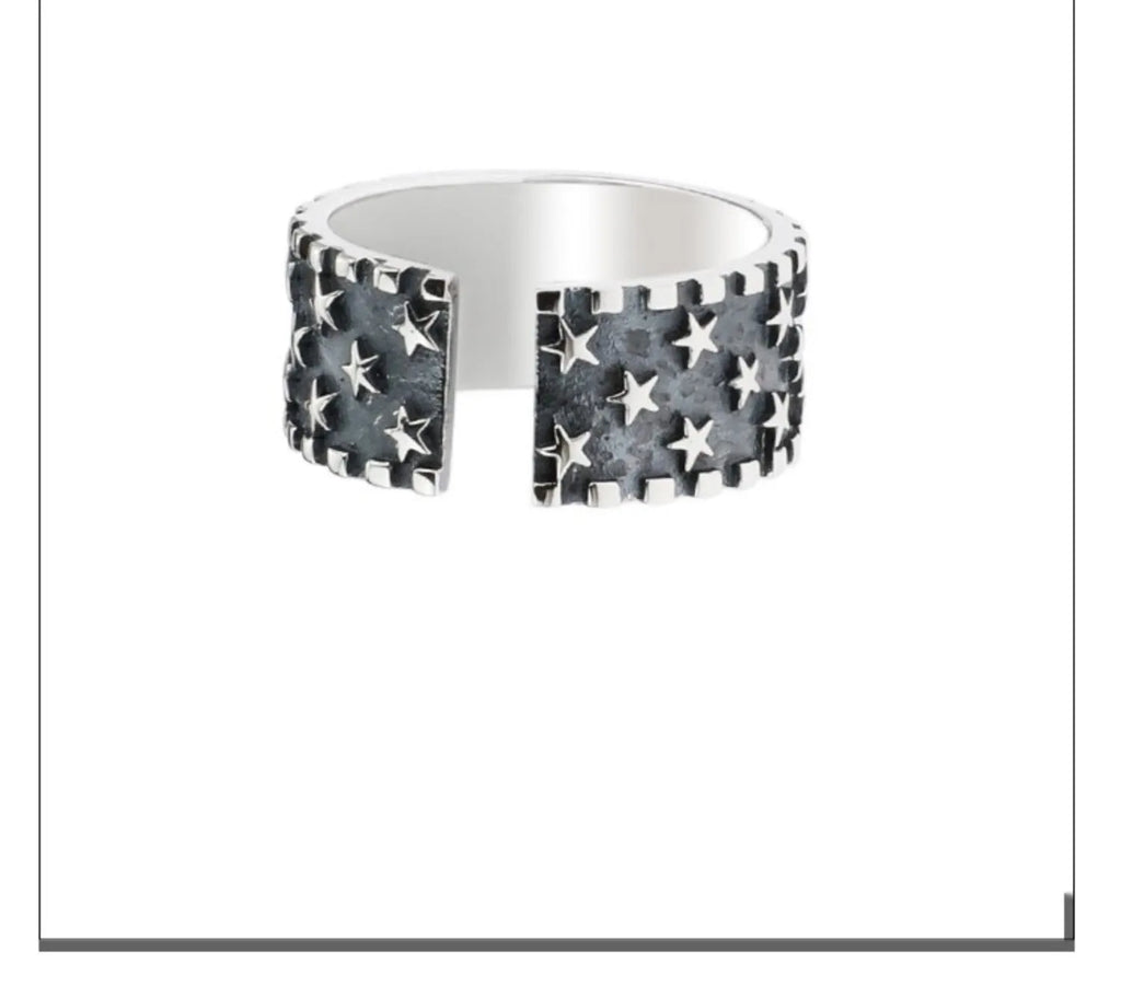 Adjustable open-ended sterling silver ring with a multi five-pointed star geometric pattern.