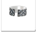 Adjustable open-ended sterling silver ring with a multi five-pointed star geometric pattern.