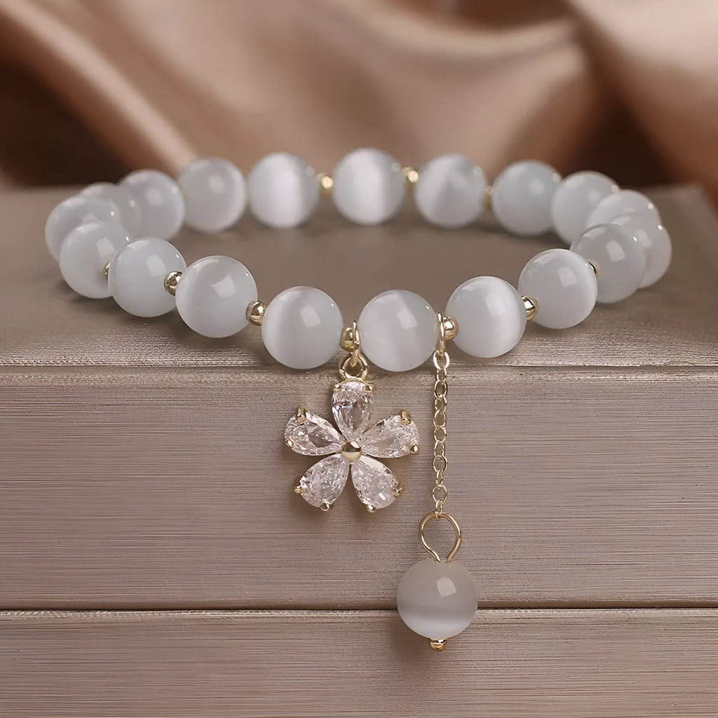 White cat's eye stone women's bracelet with safety buckle pendant and flower tassel detailing