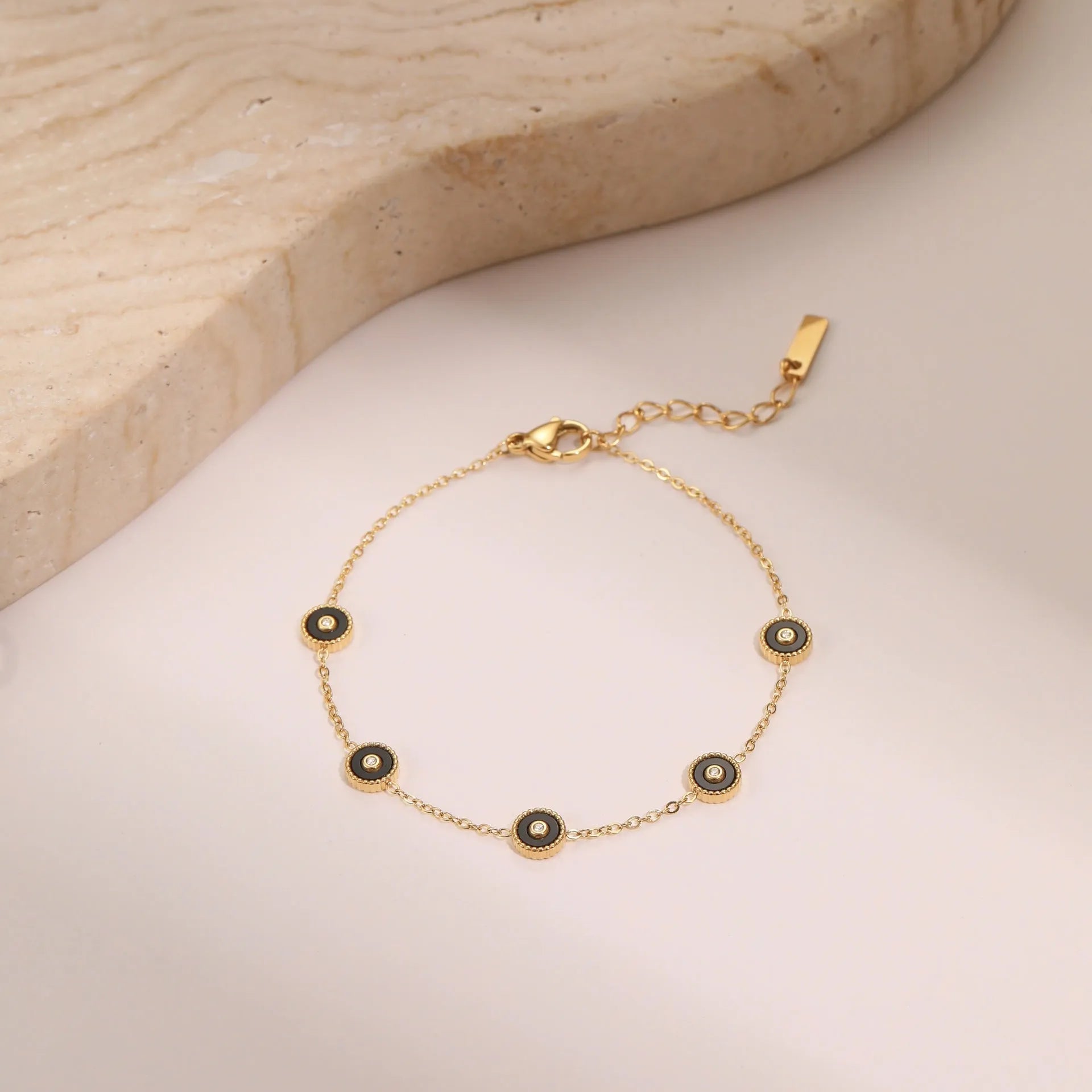 Geometric fritillary pattern stainless steel bracelet with 18K gold plating and matching necklace