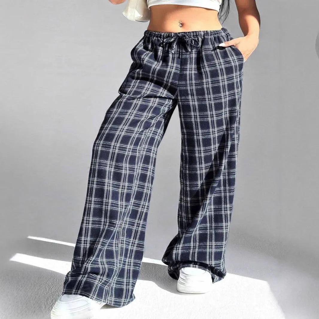 Women's red loose fit casual trousers with drawstring waist and plaid pockets, laid flat.