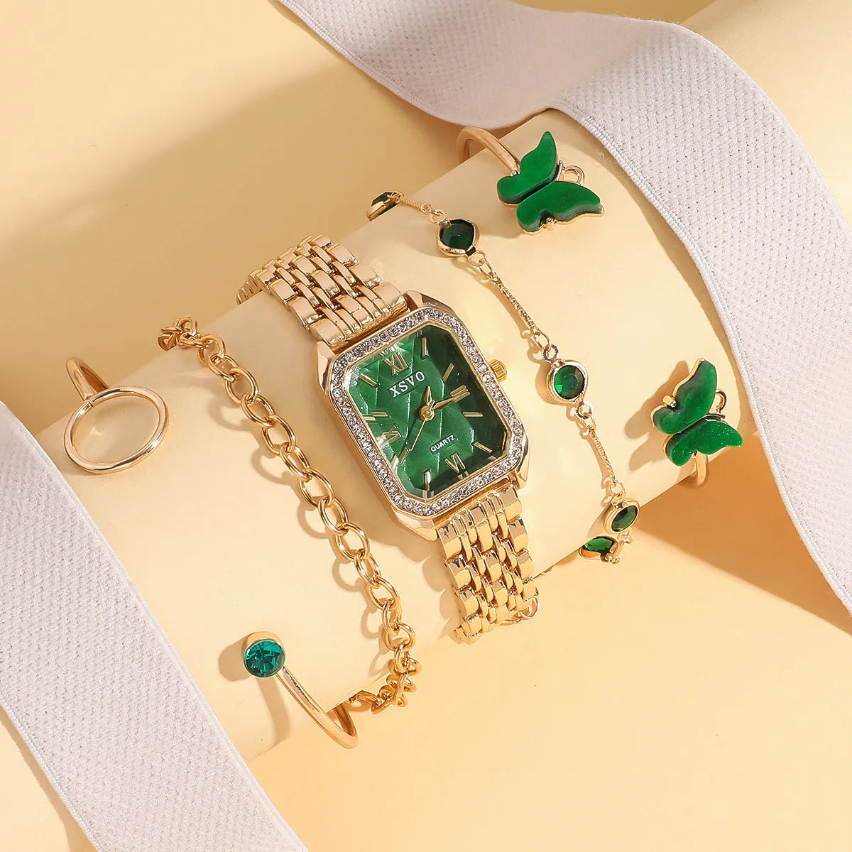 Gold green square dial women's watch with four matching alloy bracelets displayed together