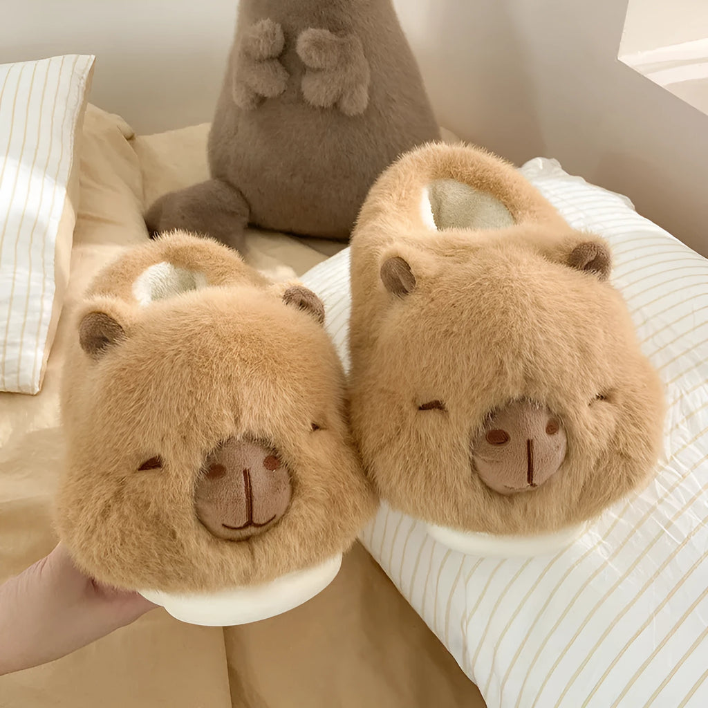 Light brown women's winter slippers with cotton plush upper and cartoon pattern.