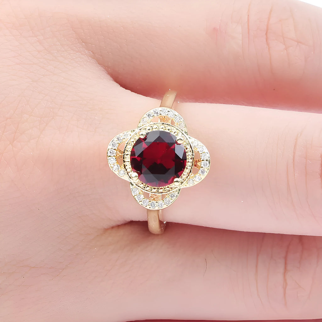 Copper fruit-shaped ring with a zircon stone inlay on a hand.