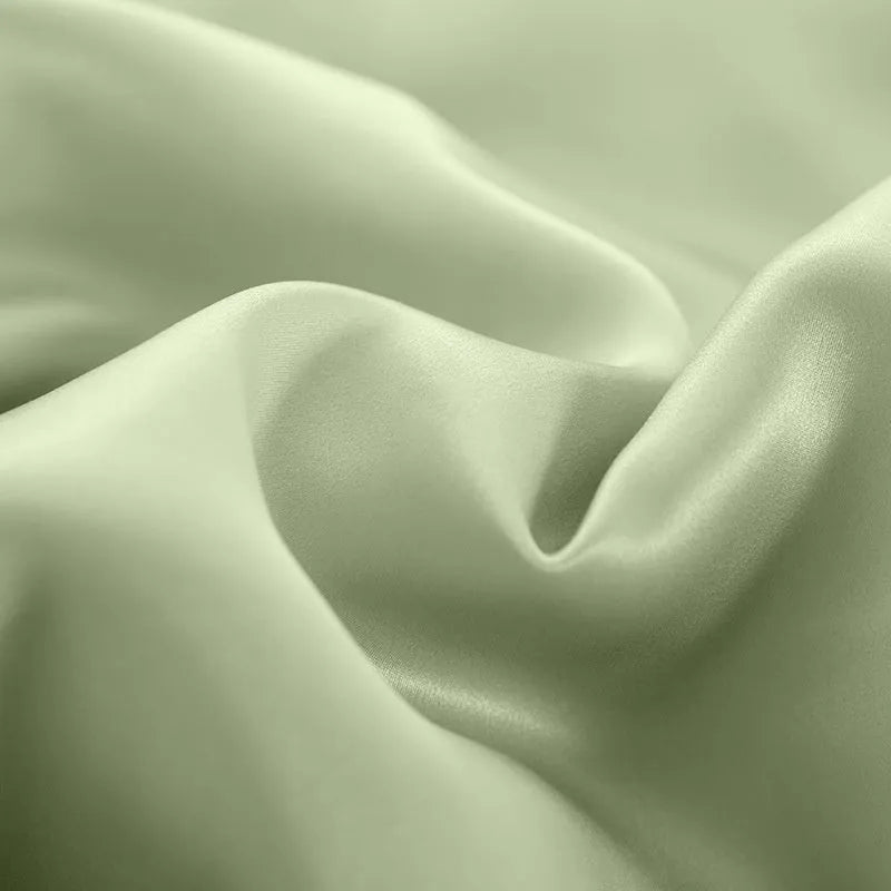 Solid colour silk duvet cover laid flat, showing double-sided construction and smooth texture.