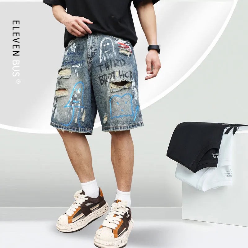 Blue men's ripped denim shorts with graffiti details and a straight leg opening.