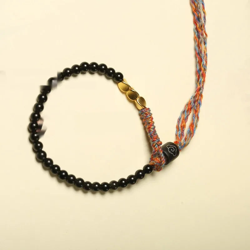 Hand-woven obsidian bead bracelet strap on a wrist, showing its 4mm width and dark colour.