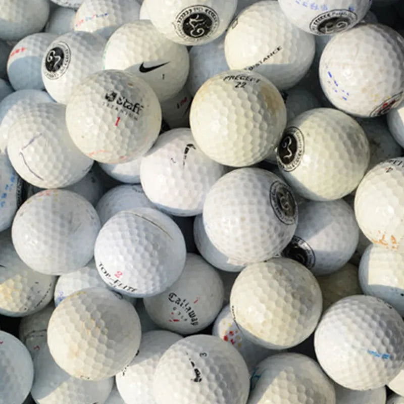 White Golf Next practice game ball with 352 beehive dimples on grass