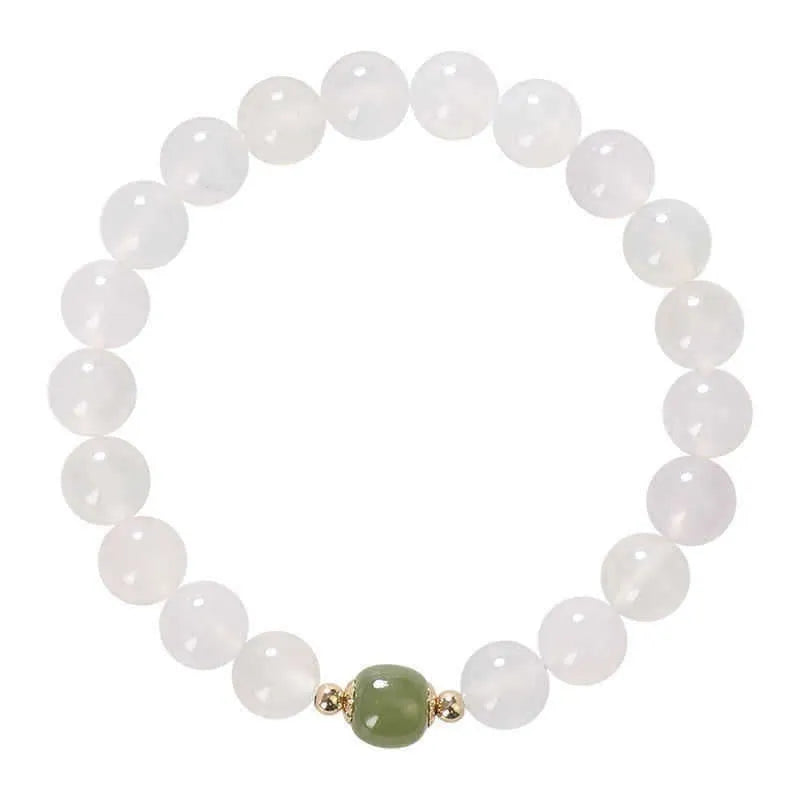 Handmade white agate crystal bracelet with cinnabar inlay showing 6mm and 8mm bead size options