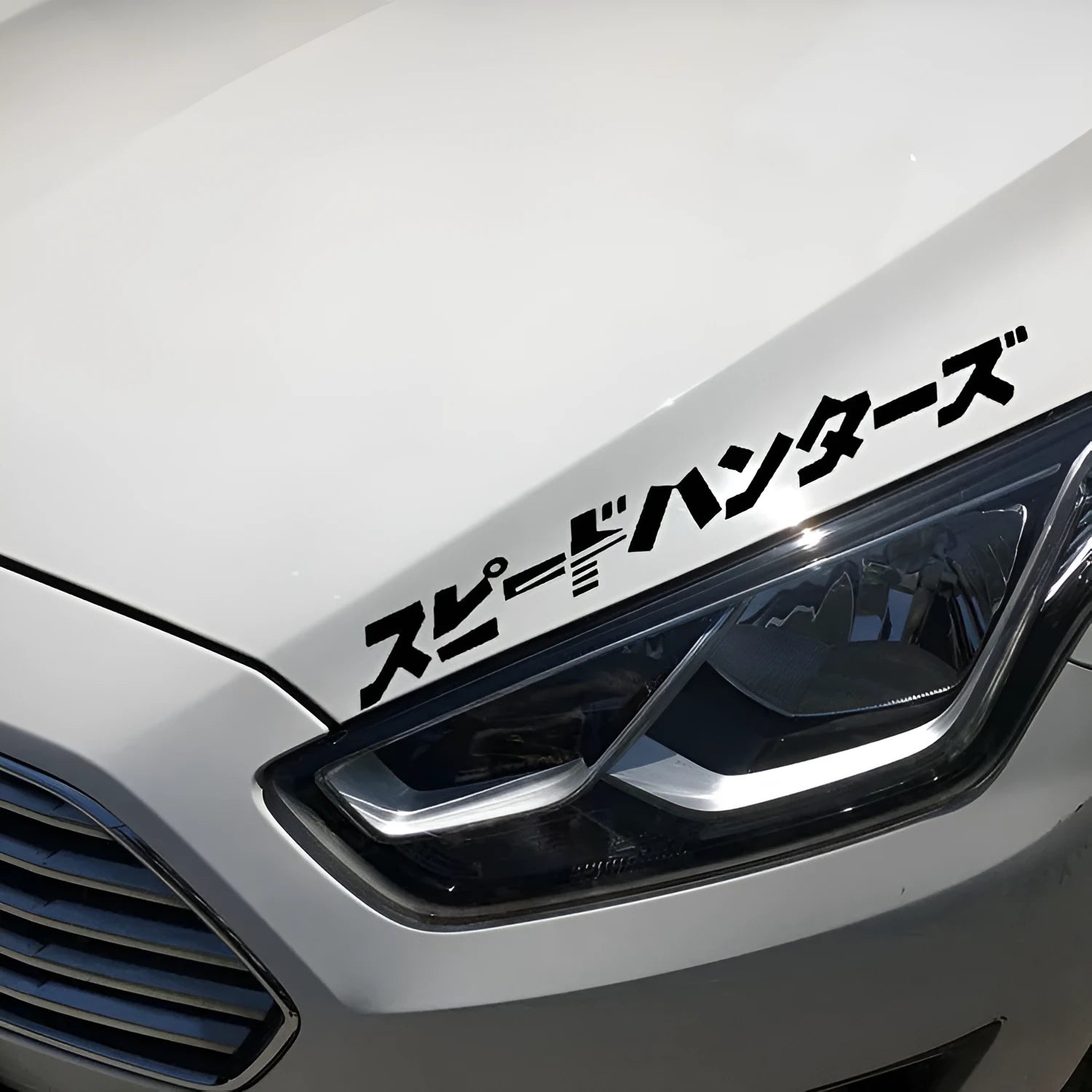 Black and white 35x35cm square reflective Japanese car sticker on a vehicle window.