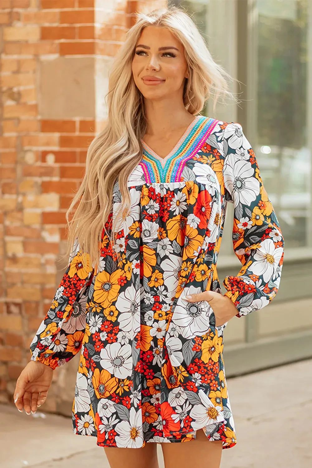 Orange floral print women's mini dress with striped lace detailing, V-neck, and long sleeves.