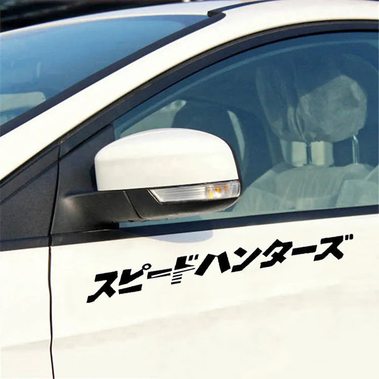 Black and white 35x35cm square reflective Japanese car sticker on a vehicle window.