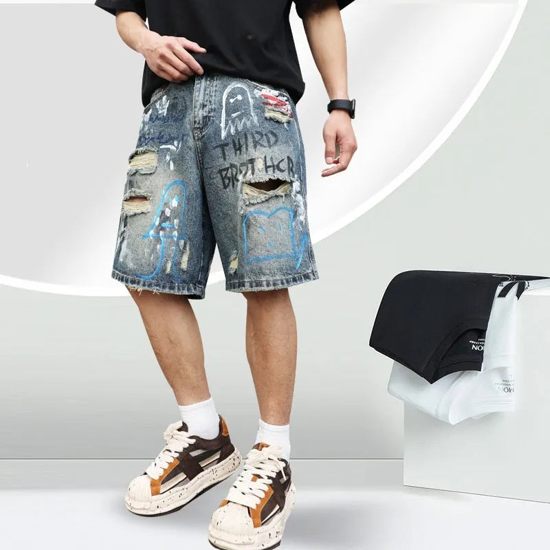 Blue men's ripped denim shorts with graffiti details and a straight leg opening.