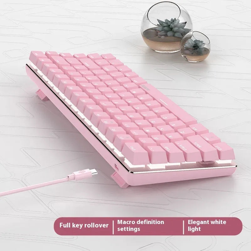 Compact white-backlit mechanical keyboard with 82 keys and metal case on a desk.